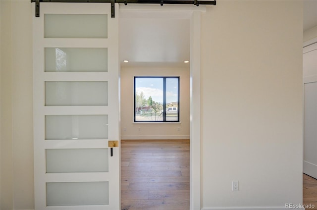 717 Marquette Ave, Buena Vista, CO 81211 - corridor with hardwood / wood-style flooring, built in shelves, a barn door, and recessed lighting