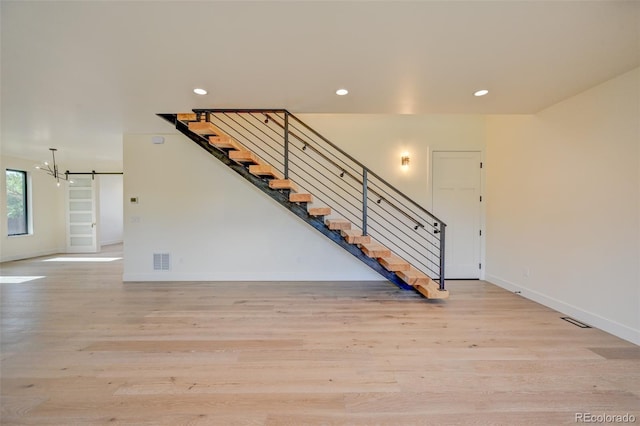 717 Marquette Ave, Buena Vista, CO 81211 - staircase featuring wood finished floors, recessed lighting, and a chandelier