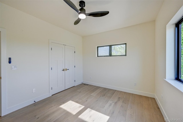 717 Marquette Ave, Buena Vista, CO 81211 - unfurnished bedroom with multiple windows, light wood-type flooring, and ceiling fan