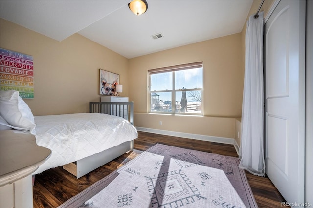 bedroom featuring dark hardwood / wood-style flooring