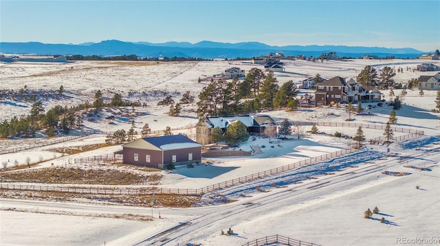 snowy aerial view with a mountain view