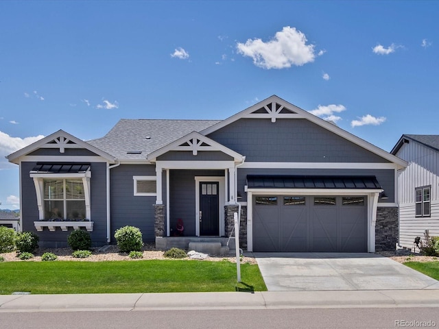 10258 W Coal Mine Pl, Littleton, CO 80127 - craftsman house with driveway, a garage, a front lawn, stone siding, and roof with shingles
