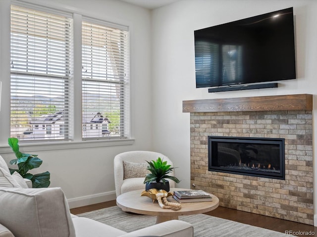 10258 W Coal Mine Pl, Littleton, CO 80127 - living area featuring healthy amount of natural light, wood finished floors, baseboards, and a fireplace