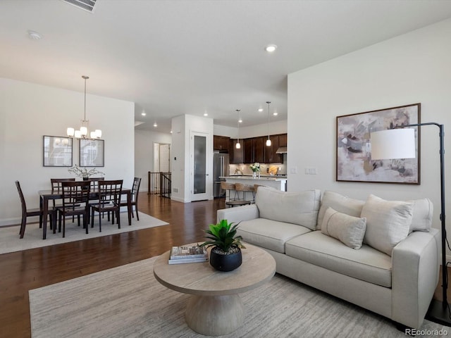 10258 W Coal Mine Pl, Littleton, CO 80127 - living room featuring dark wood-type flooring, baseboards, a chandelier, and recessed lighting