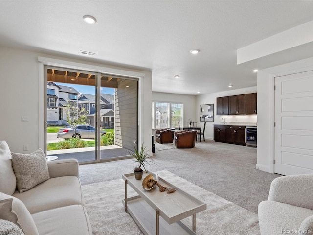 10258 W Coal Mine Pl, Littleton, CO 80127 - living room featuring light carpet, recessed lighting, and beverage cooler