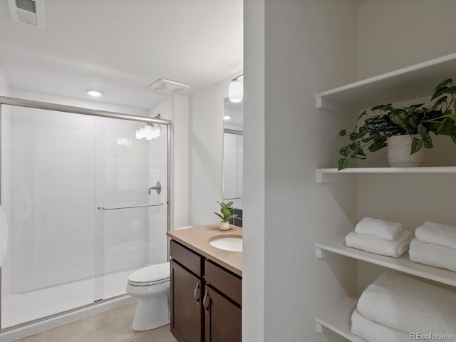 10258 W Coal Mine Pl, Littleton, CO 80127 - bathroom with a stall shower, toilet, vanity, tile patterned flooring, and recessed lighting