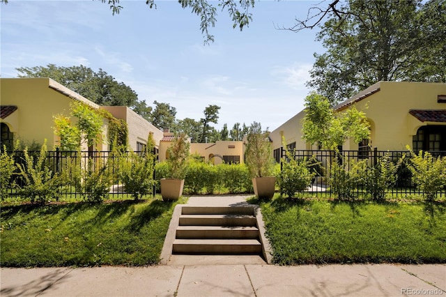 view of home's community with a lawn