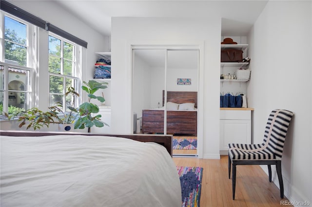 bedroom with a closet and light hardwood / wood-style floors