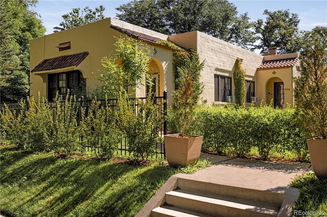 mediterranean / spanish-style house with a front lawn