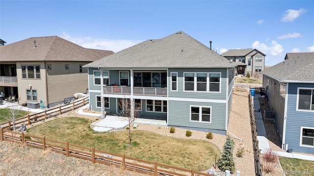 18372 W 95th Pl, Arvada, CO 80007 - back of house featuring a patio, a fenced backyard, and a shingled roof
