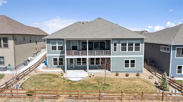 18372 W 95th Pl, Arvada, CO 80007 - back of house with a patio, a fenced backyard, a balcony, and a shingled roof