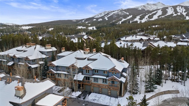 snowy aerial view with a mountain view