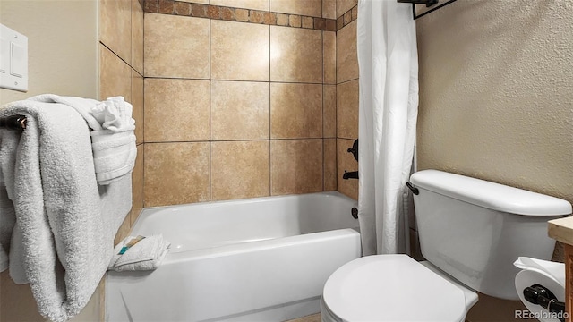 bathroom featuring shower / bath combo and toilet