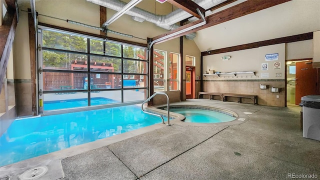 view of pool with an indoor hot tub