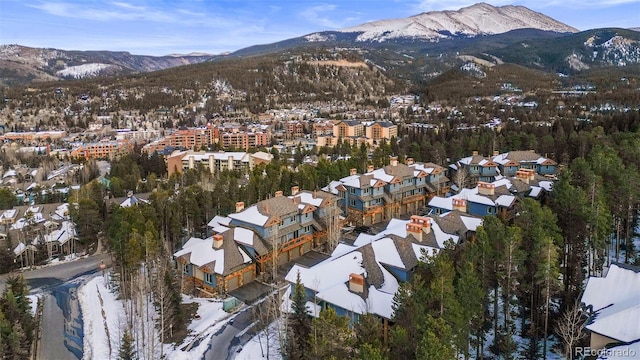 snowy aerial view featuring a mountain view