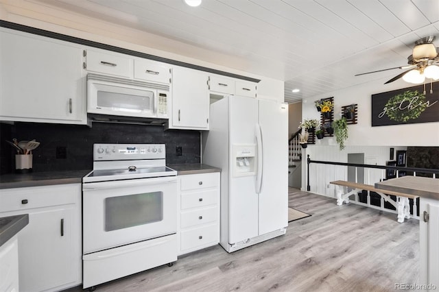 6455 Field St, Arvada, CO 80004 - kitchen with white appliances, dark countertops, backsplash, light wood-style floors, and wood ceiling