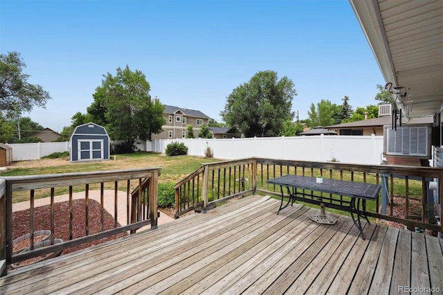 6455 Field St, Arvada, CO 80004 - wooden deck featuring a storage shed and a fenced backyard