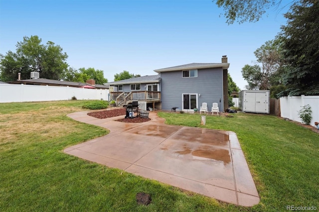 6455 Field St, Arvada, CO 80004 - rear view of property with a chimney, a storage shed, a fenced backyard, a patio area, and a wooden deck