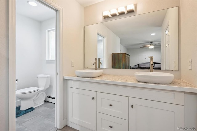 6455 Field St, Arvada, CO 80004 - full bathroom featuring a baseboard radiator, double vanity, tile patterned flooring, ceiling fan, and recessed lighting