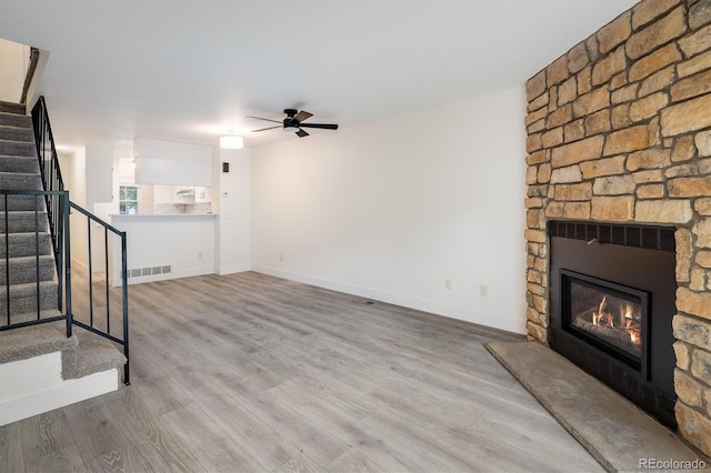 2933 W 81st Ave Unit F, Westminster, CO 80031 - unfurnished living room featuring stairs, ceiling fan, a fireplace, and wood finished floors