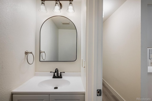 2933 W 81st Ave Unit F, Westminster, CO 80031 - bathroom with wood finished floors and vanity