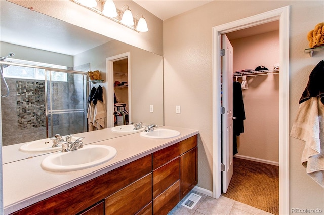 13241 Heart Lake Way, Broomfield, CO 80020 - full bath featuring a spacious closet, double vanity, a stall shower, and tile patterned flooring