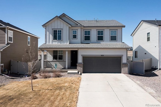 view of front of house featuring board and batten siding, fence, concrete driveway, covered porch, and a garage