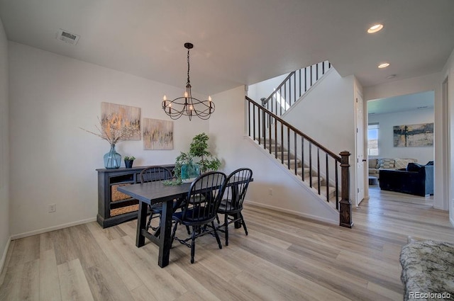 dining space with stairs, baseboards, visible vents, and light wood-type flooring