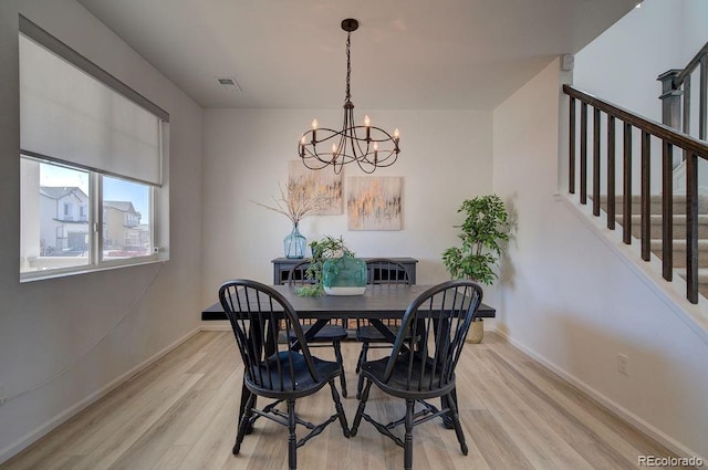 dining area with stairs, light wood-style flooring, baseboards, and visible vents