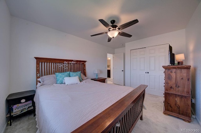 bedroom featuring light carpet, ceiling fan, and a closet