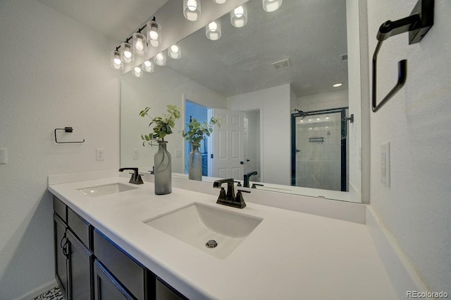 full bathroom featuring a sink, visible vents, a stall shower, and double vanity