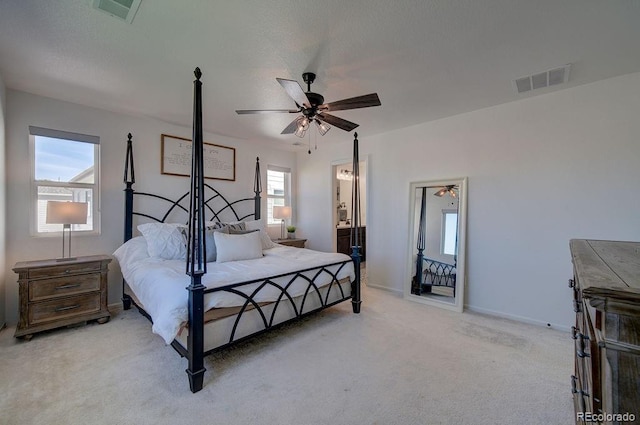 bedroom featuring light carpet, visible vents, a ceiling fan, and baseboards