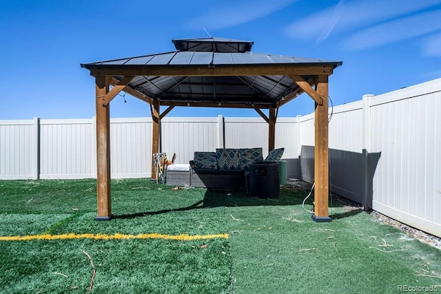 view of yard featuring a gazebo and a fenced backyard