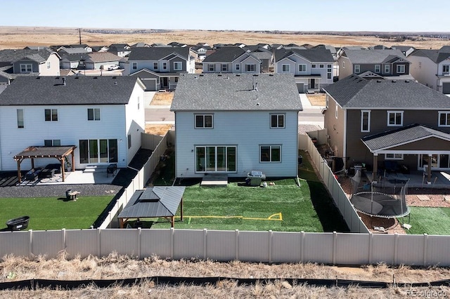 rear view of house with a residential view, a fenced backyard, and a patio area