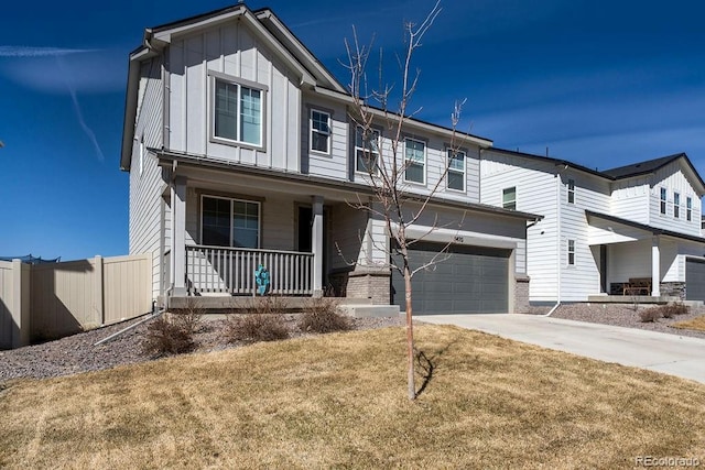 view of front facade featuring brick siding, board and batten siding, a porch, driveway, and an attached garage