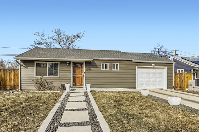 ranch-style home featuring a garage and a front yard