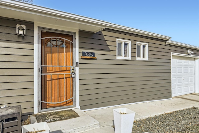 doorway to property with a garage