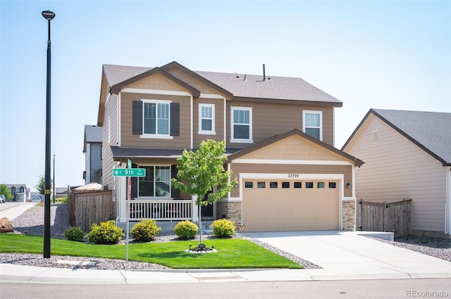 craftsman house with a front lawn, driveway, covered porch, and fence