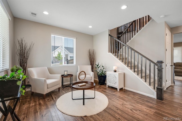 sitting room featuring stairs, wood finished floors, visible vents, recessed lighting, and baseboards
