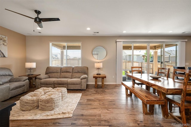living area with wood finished floors, a ceiling fan, visible vents, baseboards, and recessed lighting