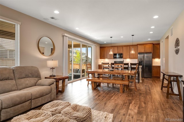 living area with recessed lighting, visible vents, and hardwood / wood-style flooring
