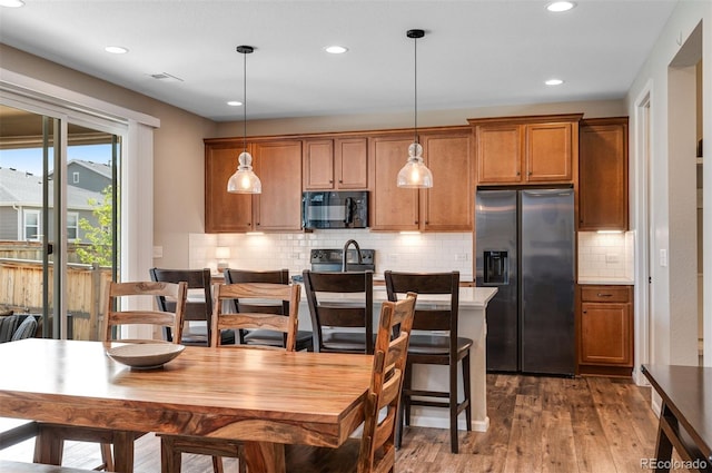 dining space featuring dark wood finished floors, recessed lighting, and visible vents