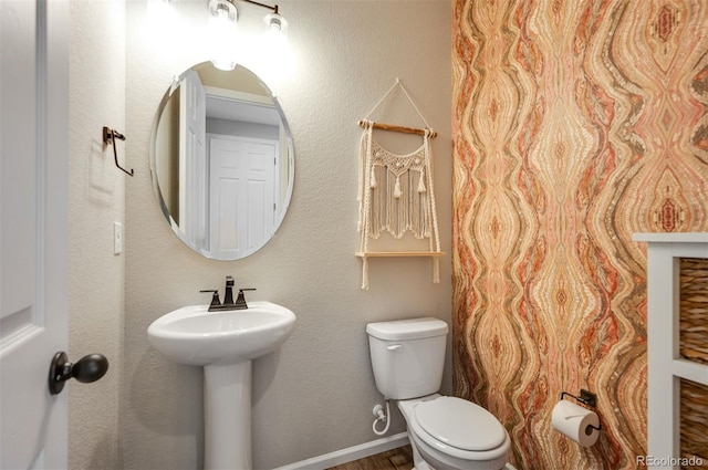 half bathroom featuring toilet and wood finished floors