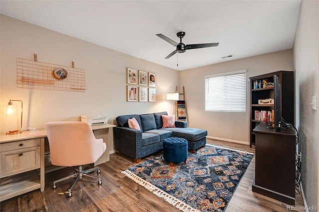 office space featuring baseboards, dark wood finished floors, ceiling fan, and visible vents