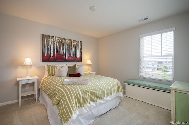 bedroom featuring baseboards, light carpet, and visible vents