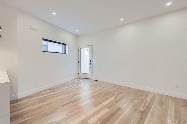 empty room with light hardwood / wood-style flooring