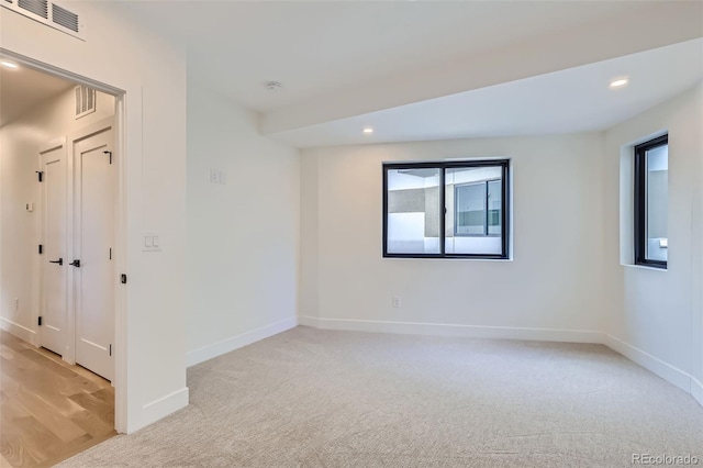 unfurnished room with light carpet