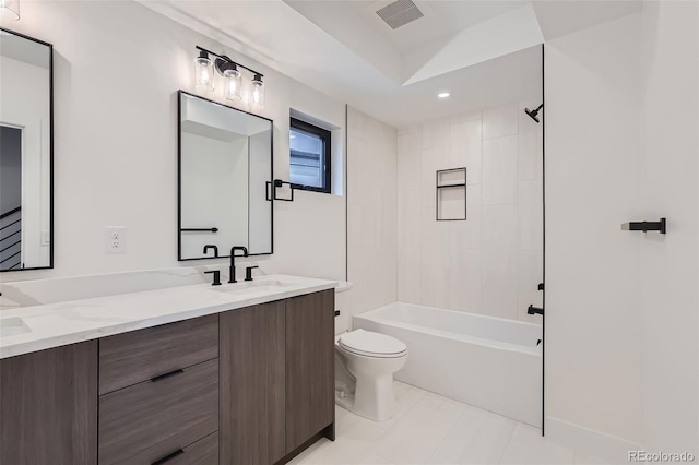 full bathroom featuring toilet, tiled shower / bath, and vanity