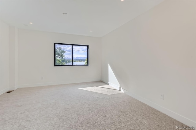 empty room with light colored carpet