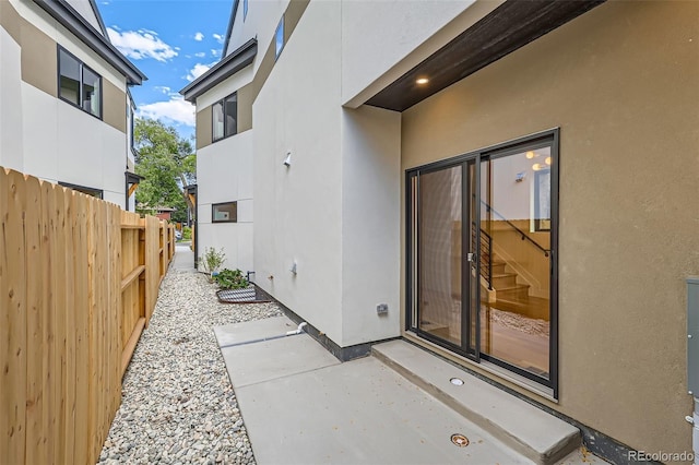 view of exterior entry featuring a patio